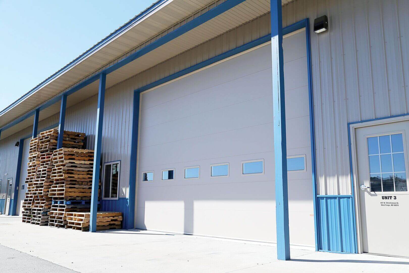Industrial building with stacked wooden pallets.