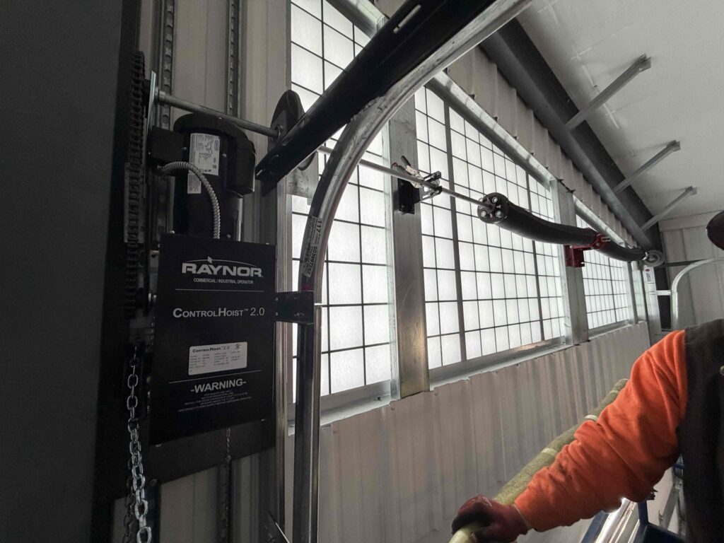 Garage door opener and torsion spring mechanism